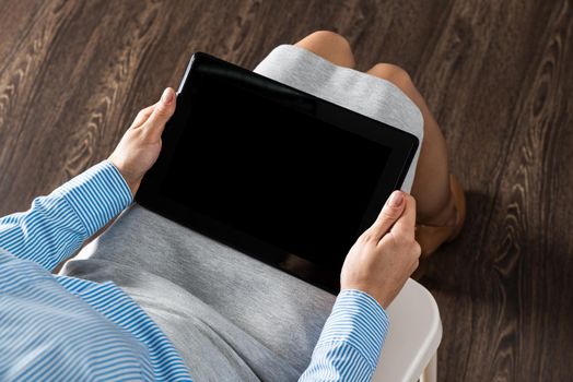 close-up of female hands with a computer tablet