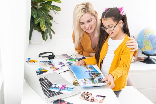 Mom and daughter watch family photo album