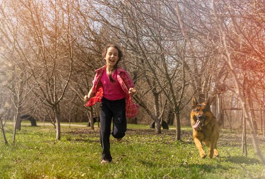 girl, child summer Sunny day walking on a green grassy meadow.