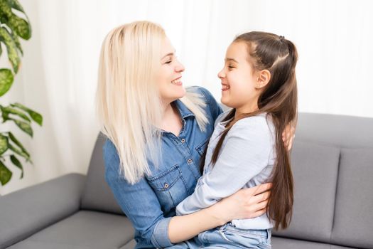 Mom with her pre teen daughter hugging, positive feelings, good relations