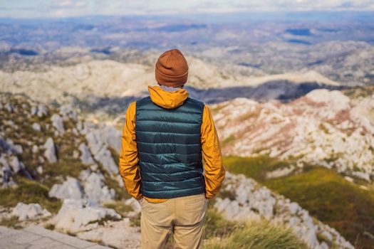 Man traveller in mountain landscape at national park Lovcen, Montenegro. Travel to Montenegro concept.