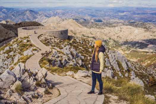 Woman traveller in mountain landscape at national park Lovcen, Montenegro. Travel to Montenegro concept.