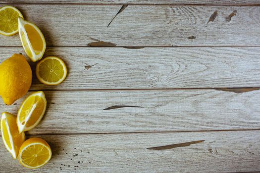 fresh sliced lemon on wooden natural background with space for text