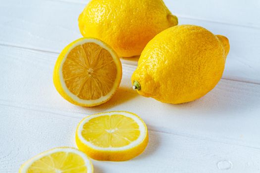 fresh sliced lemon on white wooden natural background