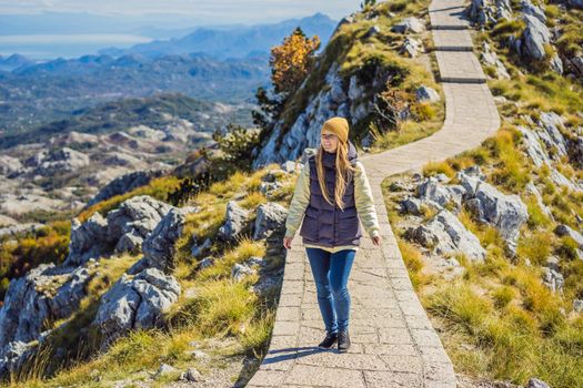 Woman traveller in mountain landscape at national park Lovcen, Montenegro. Travel to Montenegro concept.