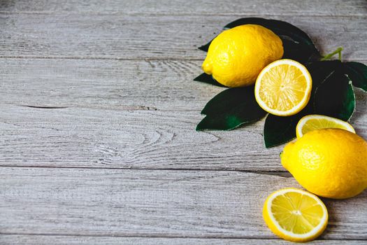 fresh sliced lemon on wooden natural background with space for text