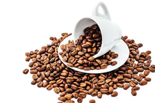 white cup with coffee beans isolated