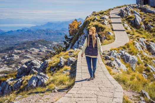 Woman traveller in mountain landscape at national park Lovcen, Montenegro. Travel to Montenegro concept.