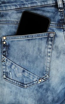 Close up one black smartphone in jeans back pocket, low angle rear view
