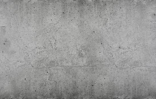 Grunge grey uneven stone texture background with cracks and stains