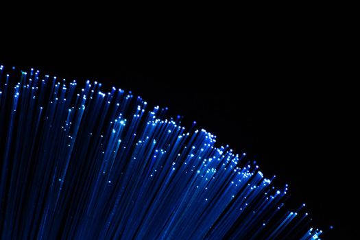 perfectly focused arc shaped blue fiber optic lights on black background