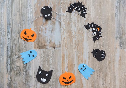 image from above of halloween motifs to decorate placed in a circle on old wooden floor