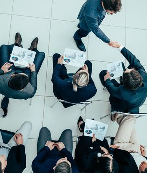 top view. business colleagues greeting each other at a business meeting.