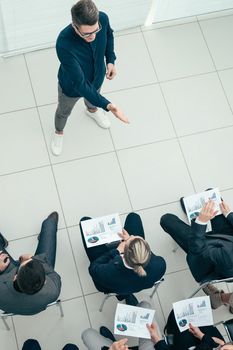 top view. boss holds a working meeting with the business team.