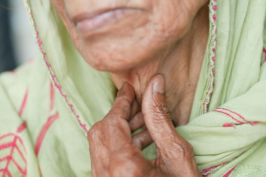 senior women suffering throat pain close up .