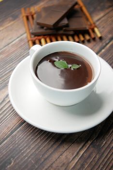 dark chocolate cream in a bowl on white .