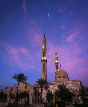 Beautiful large Islamic mosque at the sunset sky background.