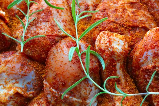 Pieces of chicken in specialties and rosemary branches