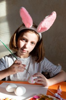 Funny photo of joyful happy family mom and little daughter having fun and fooling around while decorating Easter eggs together for spring holidays