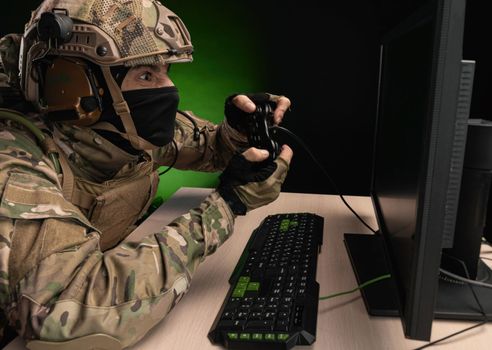 military soldier at a computer is conducting a cyber war