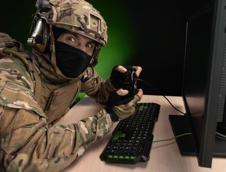 military soldier at a computer is conducting a cyber war