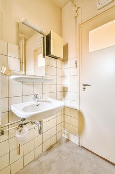 The interior of a spacious bathroom in a cozy apartment with a sink and a mirror