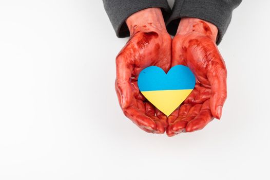 Woman with hands covered in blood holding a heart with the flag of ukraine on a white background