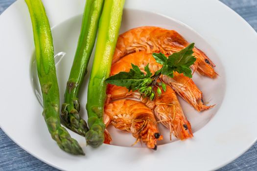 Large shrimp on green asparagus