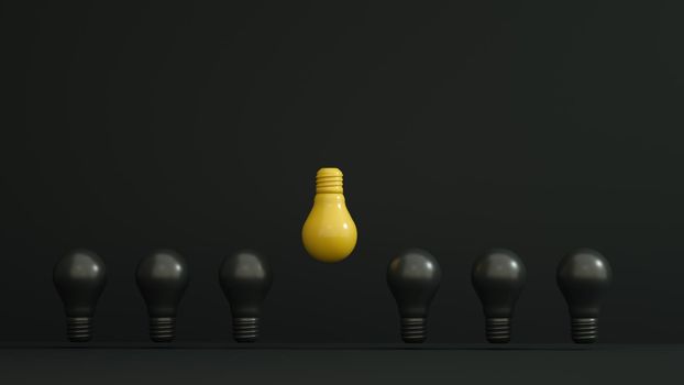 Yellow bulb inverted and higher among black bulbs on dark background. Leadership, innovation,authority, great idea and individuality concepts. . High quality photo