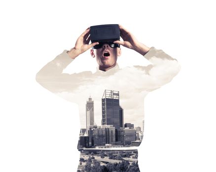 Young man with virtual reality headset or 3d glasses over cityscape background