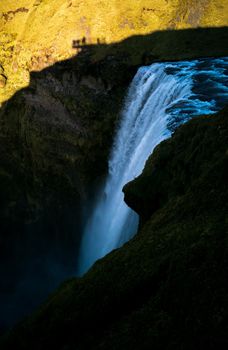 Top of skogafoss waterfall with viewpoint shadow, vertical composition
