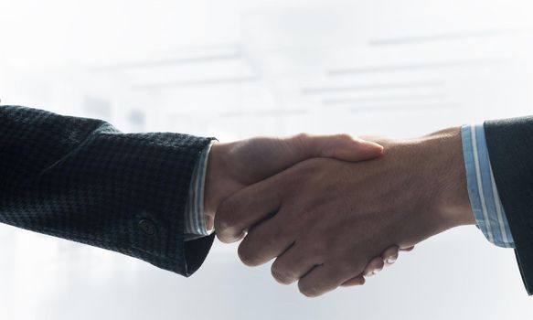 A close-up of a handshake. Making a deal between two businessmen