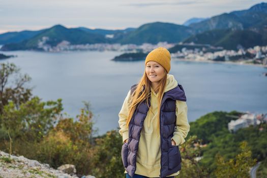 Woman in the mountains of Montenegro in warm clothes. Travel to Montenegro in spring, autumn, winter.