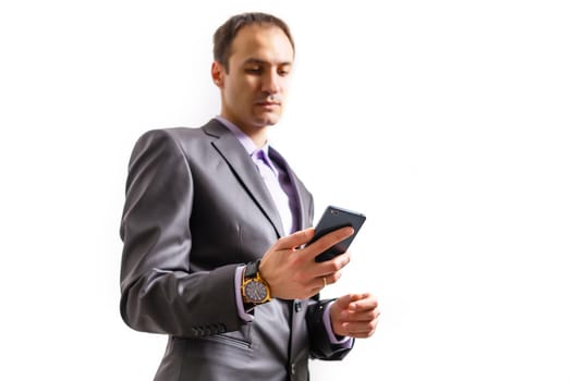 Happy businessman talking on the phone with folder in hand isolated over white background in studio shooting