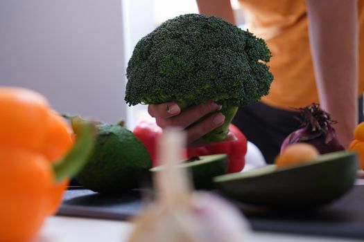 Broccoli and different vegetables in kitchen. Healthy proper nutrition and vegetarianism concept