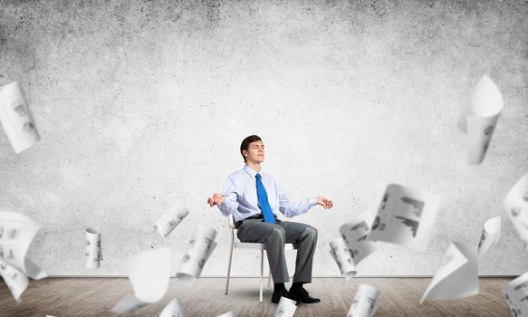 businessman sitting on an office chair, meditation and calmness