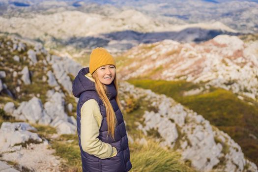 Woman traveller in mountain landscape at national park Lovcen, Montenegro. Travel to Montenegro concept.