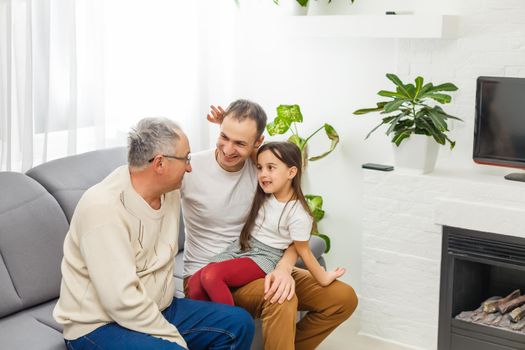 father, son and granddaughter at home