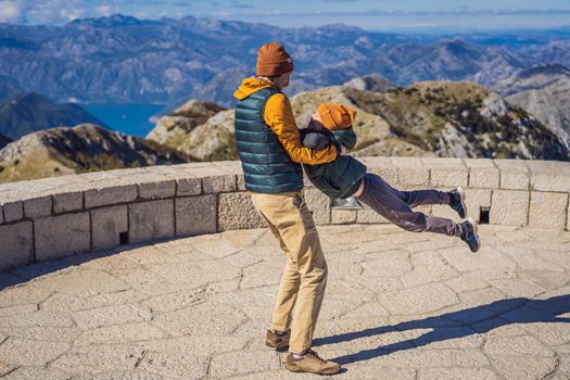 Dad and son travellers in mountain landscape at national park Lovcen, Montenegro. Travel to Montenegro with children concept.