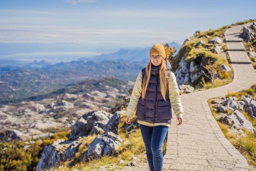 Woman traveller in mountain landscape at national park Lovcen, Montenegro. Travel to Montenegro concept.