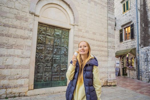 Woman tourist enjoying Colorful street in Old town of Kotor on a sunny day, Montenegro. Travel to Montenegro concept.