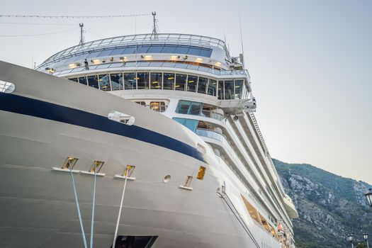 Cruise ship at harbor. Beautiful large white ship at sunset. Colorful landscape with boats in marina bay, sea. Luxury cruise. Floating liner.