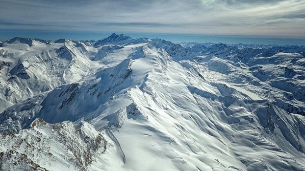 Amazing view from a drone over the snowy mountain hills