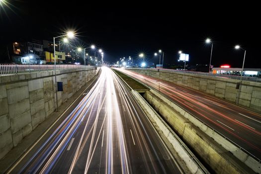 Night traffic junction road with lights of vehicle movement. Horizontal view