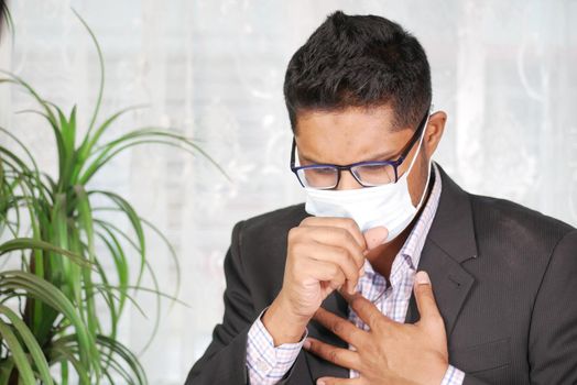 Portrait of sick man sneezes and coughs,