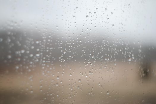Natural pattern of rain drops on window glass surface