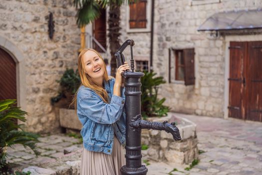 Woman tourist enjoying Colorful street in Old town of Kotor on a sunny day, Montenegro. Travel to Montenegro concept.