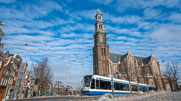 City scenic from a snowy Amsterdam in winter near the Westerkerk in the Netherlands