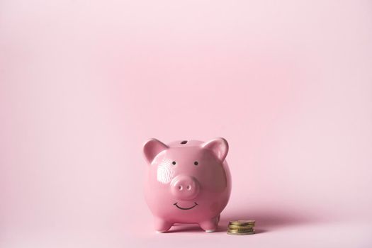 Piggy bank in the form of a smiling pink pig to save wealth, savings and financial success, close-up view.