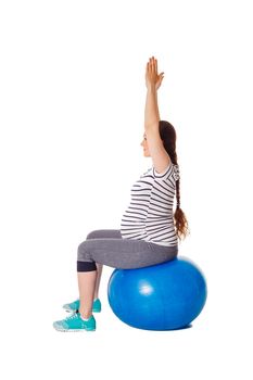 Pregnancy exercise concept - pregnant woman doing exercises with exercise ball isolated on white background
